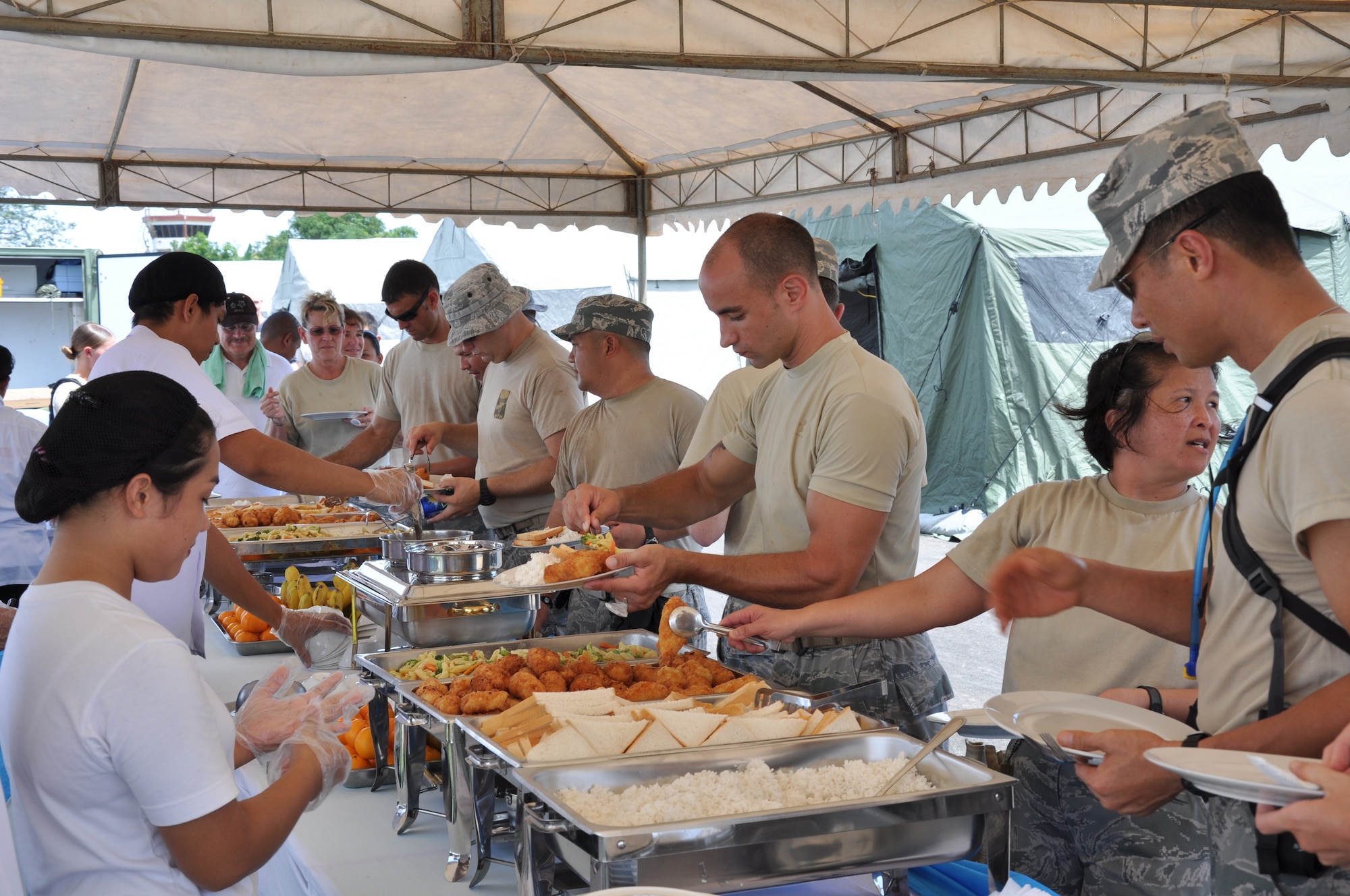 Military members in Legaspi City, Philippines, get a well deserved lunch break after setting up tents March 2 in preparation for Pacific Angel-Philippines. PACANGEL is a joint and combined humanitarian mission scheduled to begin March 5 at Tactical Operations Group 5, Legazpi, Philippines.  (U.S. Air Force photo by Lt. Robert Howard) 
