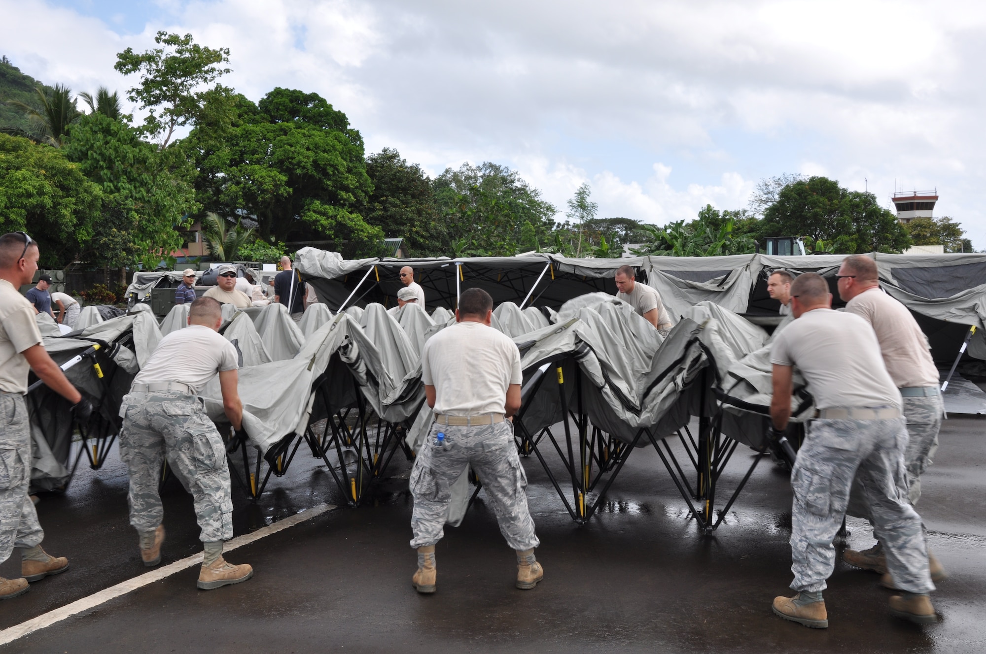 U.S. military members position themselves to set up a tent in the upright position at Tactical Operations Group 5, Legazpi City, Philippines, on March 2 for Pacific Angel-Philippines scheduled to begin March 5. The joint and combined humanitarian exercise will last six days.  (U.S. Air Force photo by Lt. Robert Howard) 


