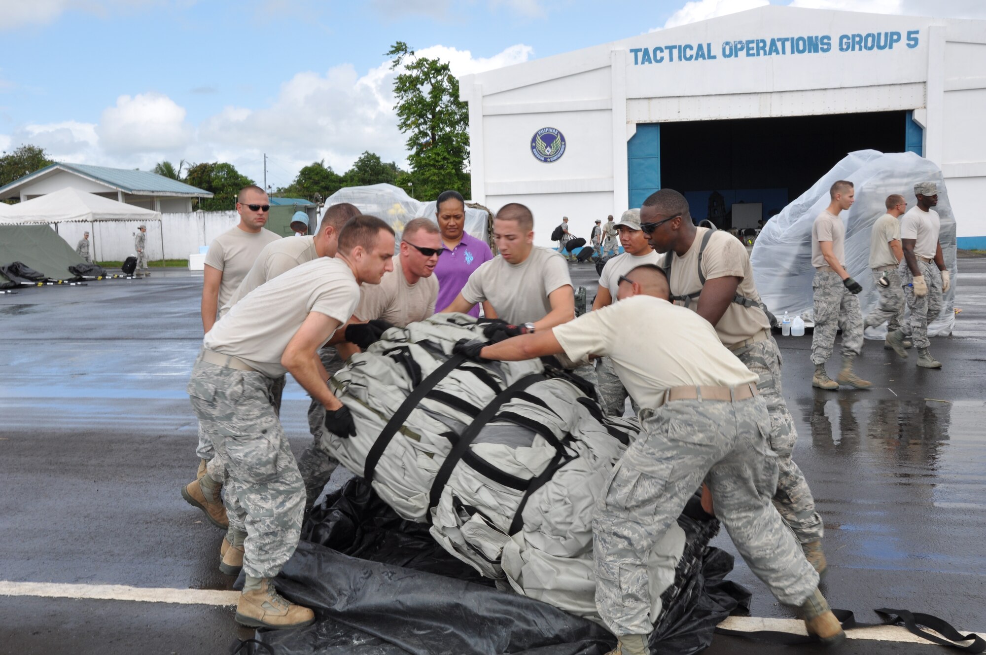 2nd Lt. Benjamin Shearer, 36th Civil Engineer Squadron at Andersen Air Force Base, Guam, and other military members navigate putting a tent in the upright position. Approximately 100 U.S. military members are based at Tactical Operations Group 5, Legazpi City, Philippines, for Pacific Angel-Philippines scheduled to begin March 5. The joint and combined humanitarian exercise will last six days.  (U.S. Air Force photo by Lt. Robert Howard) 

