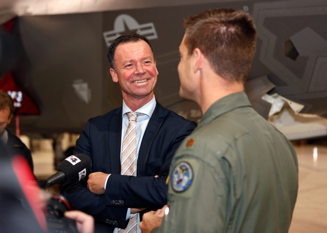 Norwegian State Secretary of Defence, Roger Ingebrigtsen, speaks with Maj. Matthew Hayden, 461st Flight Test Squadron test pilot, who was giving a plane-side brief Feb. 29 at the Joint Strike Fighter Integrated Test Force. Ingebrigtsen was visiting Edwards Air Force Base, Calif., to learn more about the F-35 and the JSF program. (U.S. Air Force photo by Jet Fabara)