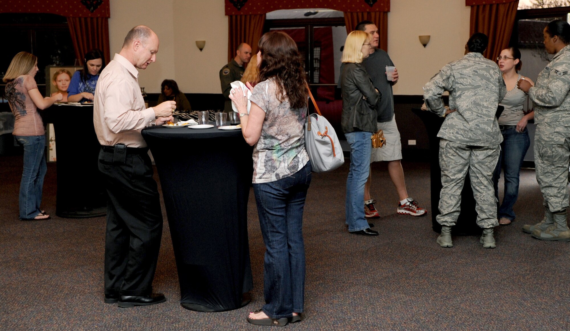 Members of Team Barksdale enjoy wine samplings and hors d'oeuvre during the First Friday Beer and Wine festival at Hangar II on Barksdale Air Force Base, La., March 2. More than 150 members attended the event which also hosted a chili cook-off and beer tasting for the Hangar's current on-tap selections. (U.S. Air Force photo/Senior Airman Amber Ashcraft)(RELEASED)