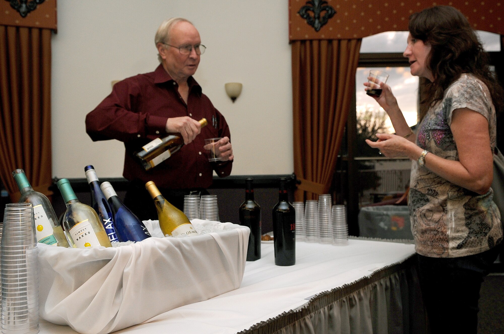 Richard Gibb, Republic National Distributing Company representative pours a sample of wine during the First Friday Beer and Wine festival at Hangar II on Barksdale Air Force Base, La., March 2. Gibb provided a variety of wine samplings to all attendees of age. (U.S. Air Force photo/Senior Airman Amber Ashcraft)(RELEASED)