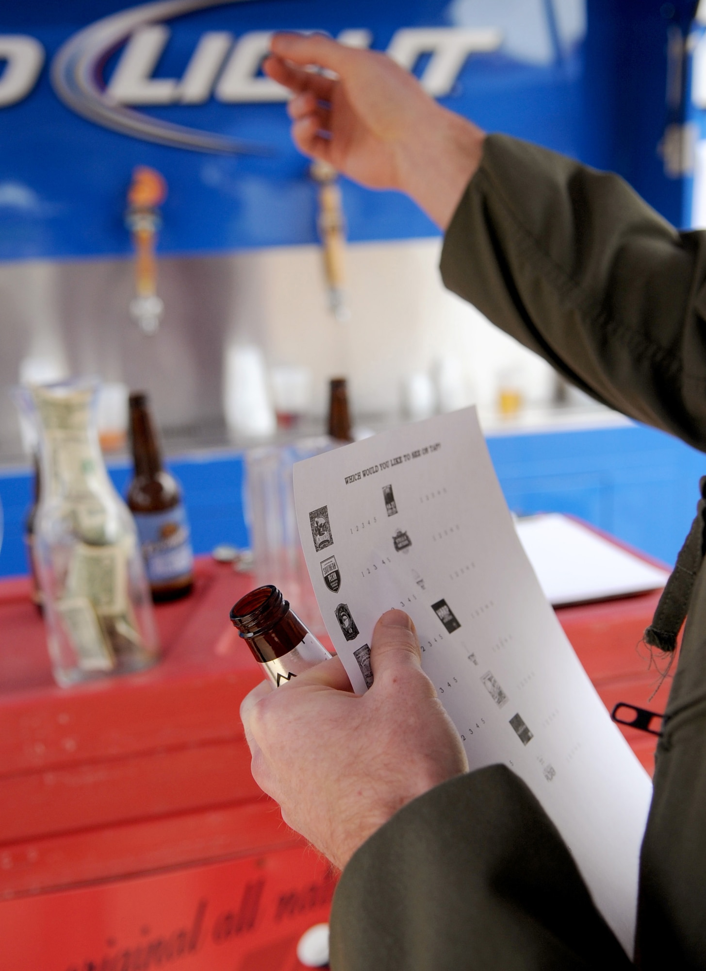 A Team Barksdale member chooses a beer sample at the First Friday Beer and Wine festival at Hangar II on Barksdale Air Force Base, La., March 2. Beer selections were available for individuals to taste and then rank which they would prefer to have on tap at Hangar II. (U.S. Air Force photo/Senior Airman Amber Ashcraft)(RELEASED)