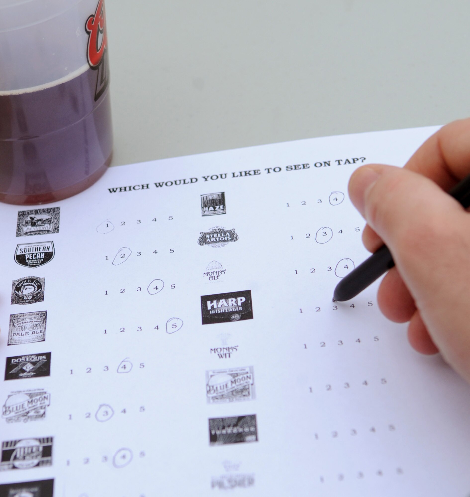 A Team Barksdale member fills out a form to rank certain beers during the First Friday Beer and Wine festival held at Hangar II on Barksdale Air Force Base, La., March 2. Beer samples were available for individuals to taste and then rank on which ones they would prefer to have on tap at Hangar II. (U.S. Air Force photo/Senior Airman Amber Ashcraft)(RELEASED)