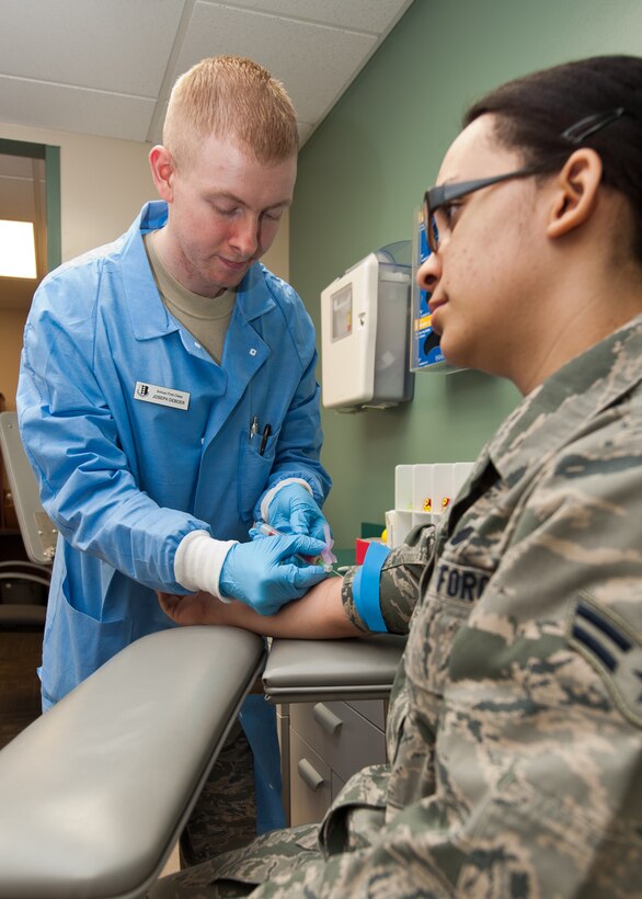 Airman 1st Class Joseph Deboer, 28th Medical Support Squadron medical laboratory technician, draws blood from Airman 1st Class Natalya Vodipija, 28th Force Support Squadron fitness specialist, during a medical evaluation at Ellsworth Air Force Base, S.D., March 1, 2012. The medical laboratory sends these samples to the medical facility at the Air Force Academy in Colorado Springs, Colo., for further analysis. (U.S. Air Force photo by Airman Alystria Maurer/Released)