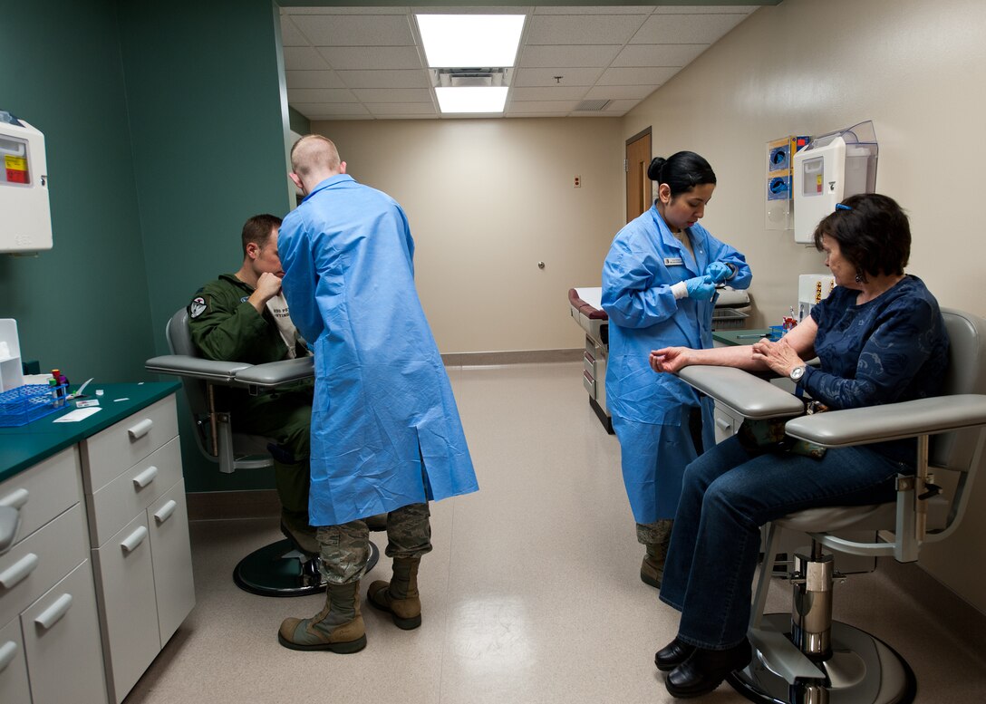 Medical technicians from the 28th Medical Support Squadron laboratory, draw blood from patients during daily operations at the 28th Medical Group on Ellsworth Air Force Base, S.D., March 1, 2012. The 28th MSS laboratory tests bodily fluids to give accurate results during medical evaluations. (U.S. Air Force photo by Airman Alystria Maurer/Released)