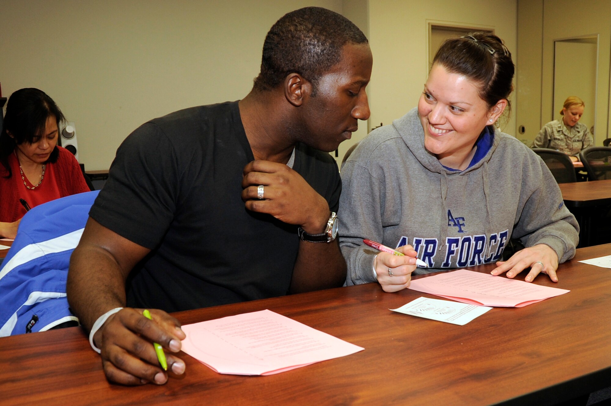 U.S. Air Force Tech. Sgt. Chris Cauthen, 35th Operations Support Squadron special security representative, and spouse Tech. Sgt. Jessica Cauthen, 373rd Support Squadron systems security office NCO in charge, complete questionnaire together at Misawa Air Base, Japan, March 1, 2012. The questionnaire was part of a lesson from the Happy Couples class, where the attendees learned about how people express love differently. The classes are scheduled to be held every Thursday from 5 p.m. to 7 p.m. at the Torii Building until the end of March. For more information about the class contact the Airman and Family Readiness Center. (U.S. Air Force photo by Airman 1st Class Kaleb Snay/Released)