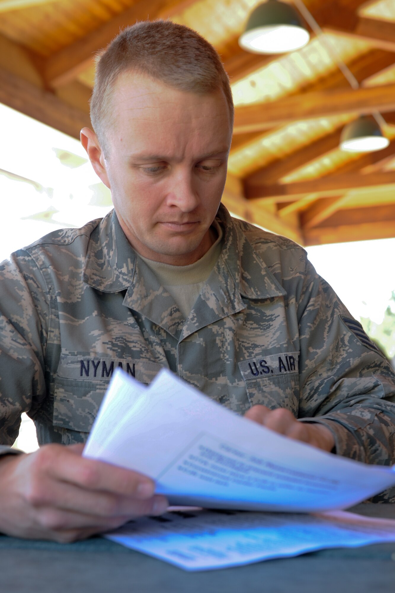 VANDENBERG AIR FORCE BASE, Calif. -- Staff Sgt. Michael Nymen, a 576th Flight Test Squadron electrical mechanical technician, looks at retraining statistics during a Lunch-and-Learn event at Cocheo Park here Friday, March 2, 2012. Team V members that attended the event learned how to assist their troops and themselves if they decide to retrain. (U.S. Air Force photo/Staff Sgt. Levi Riendeau)

