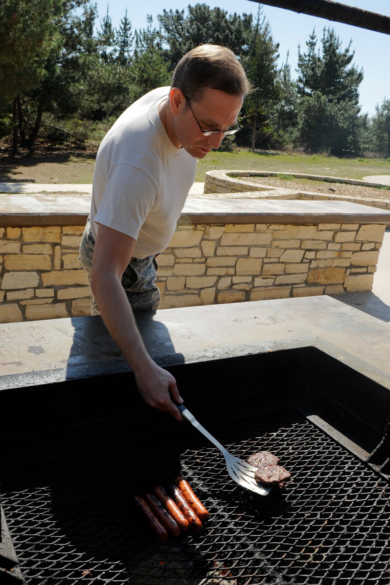 VANDENBERG AIR FORCE BASE, Calif. -- Master Sgt. Micah Snider, Vandenberg's Top 3 Lunch-and-Learn coordinator, flips burgers for Lunch-and-Learn participants at Cocheo Park here Friday, March 2, 2012. Team V members that attended the event learned how to assist their troops and themselves if they decide to retrain. (U.S. Air Force photo/Staff Sgt. Levi Riendeau)
