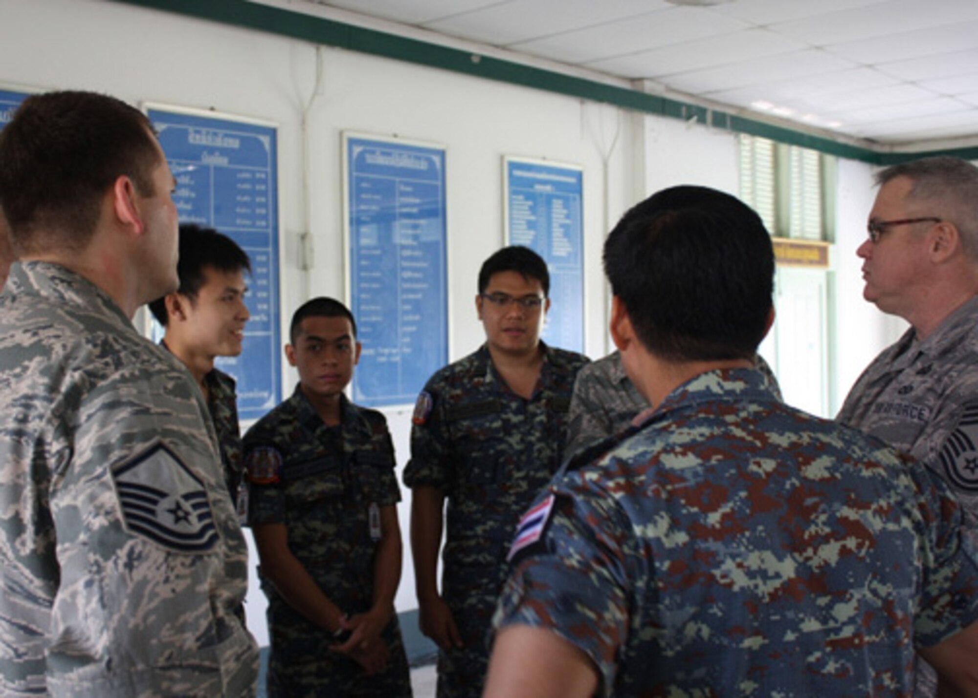 Intelligence personnel from Missouri and Thailand operating in the coalition air operations center take a moment to make introductions at the beginning of Cobra Gold at Camp Suranaree, in Korat, Thailand. Cobra Gold is an annual Thai and U.S. co-sponsored joint and multinational exercise that is designed is to improve partner nation interoperability and capacity to conduct joint and multinational planning, operations and to respond to crises with increased speed of response, mission effectiveness, and unity of effort. (Courtesy Photo, Royal Thai Air Force)