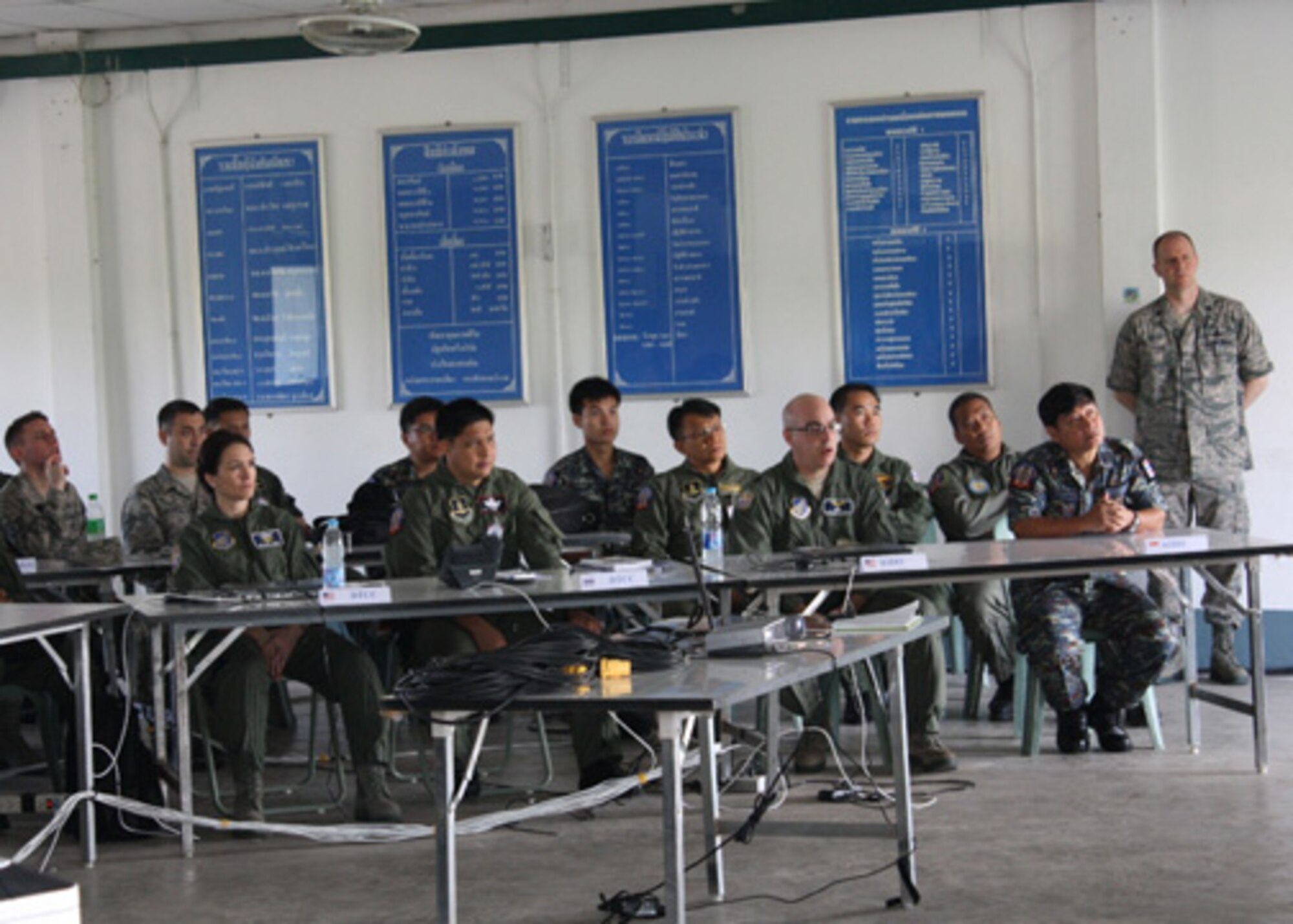 American, Thai and Singaporean Airmen listen to the Air Operations Center in-brief at the start of Cobra Gold 2012 at Camp Suranaree in Korat, Thailand. Cobra Gold is an annual Thai and U.S. co-sponsored joint and multinational exercise that is designed is to improve partner nation interoperability and capacity to conduct joint and multinational planning, operations and to respond to crises with increased speed of response, mission effectiveness, and unity of effort. (Courtesy Photo, Royal Thai Air Force)