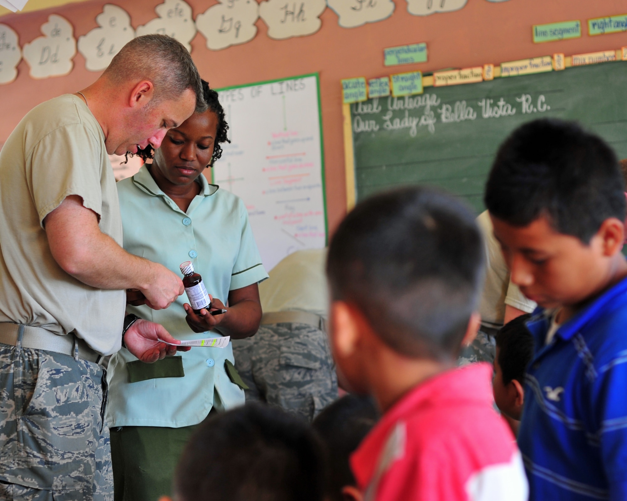 Master Sgt. Michael Atkins, the Joint Task Force-Bravo Medical Element radiology NCO in charge, discusses a prescription with a member of the Belizean Ministry of Health during the joint medical readiness training exercise in Bella Vista, Belize, Feb. 28, 2012. Members from the Belize Ministry of Health, Belizean military and JTF-Bravo, which is out of Soto Cano Air Base, Honduras, provided medical services to approximately 620 members of the local area. (U.S. Air Force photo/Staff Sgt. Bryan Franks)