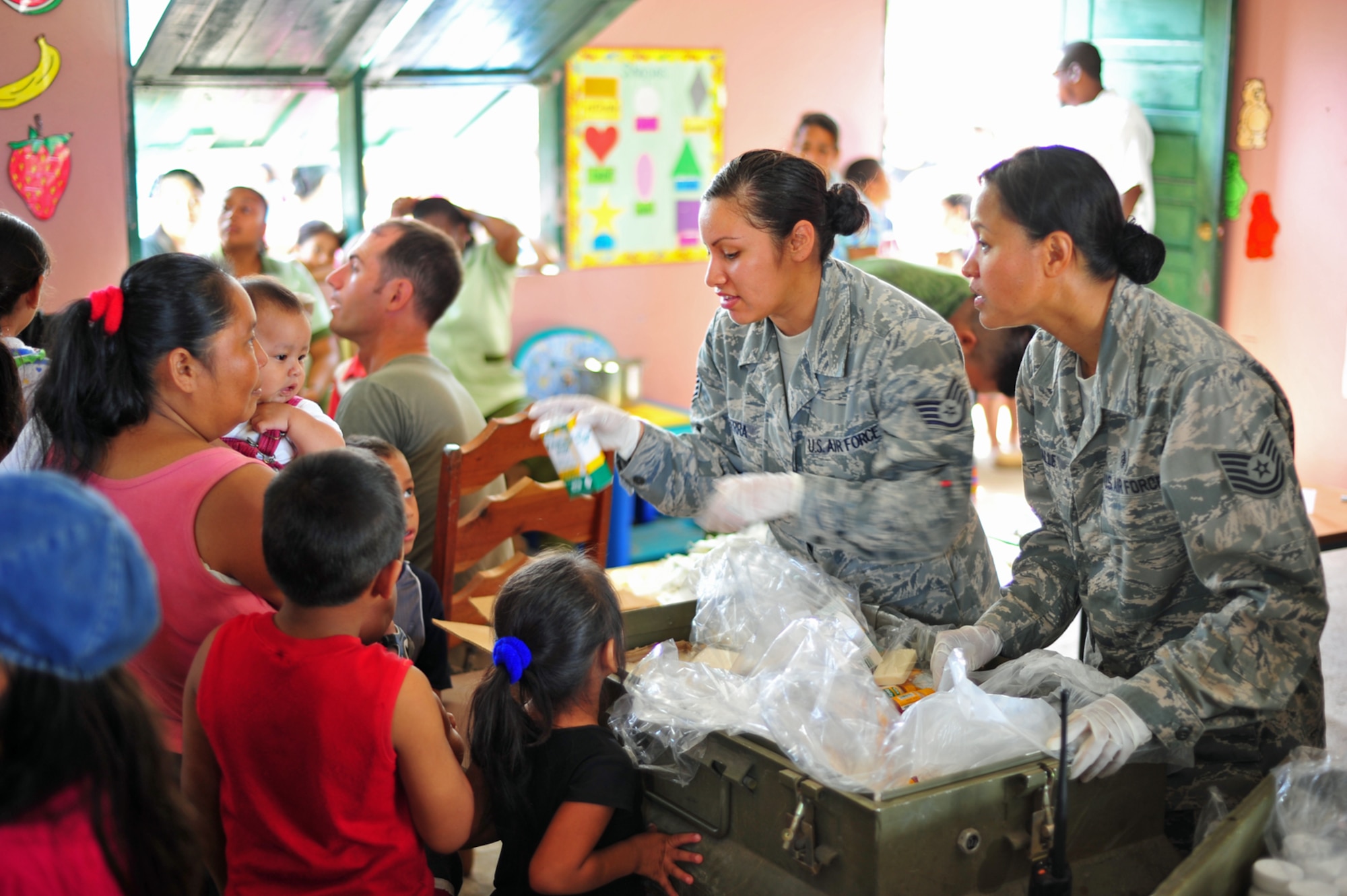Tech. Sgt. Corazon Palle and Staff Sgt. Deanna Sierra, both medical technicians with the Joint Task Force-Bravo Medical Element, distribute vitamins, de-wormer and sanitation supplies to community members in Bella Vista, Belize, Feb. 28, 2012. Members from the Belize Ministry of Health, Belizean military and JTF-Bravo provided medical services to approximately 620 people in the area. JTF-Bravo is out Soto Cano Air Base, Honduras. (U.S. Air Force photo/Staff Sgt. Bryan Franks)