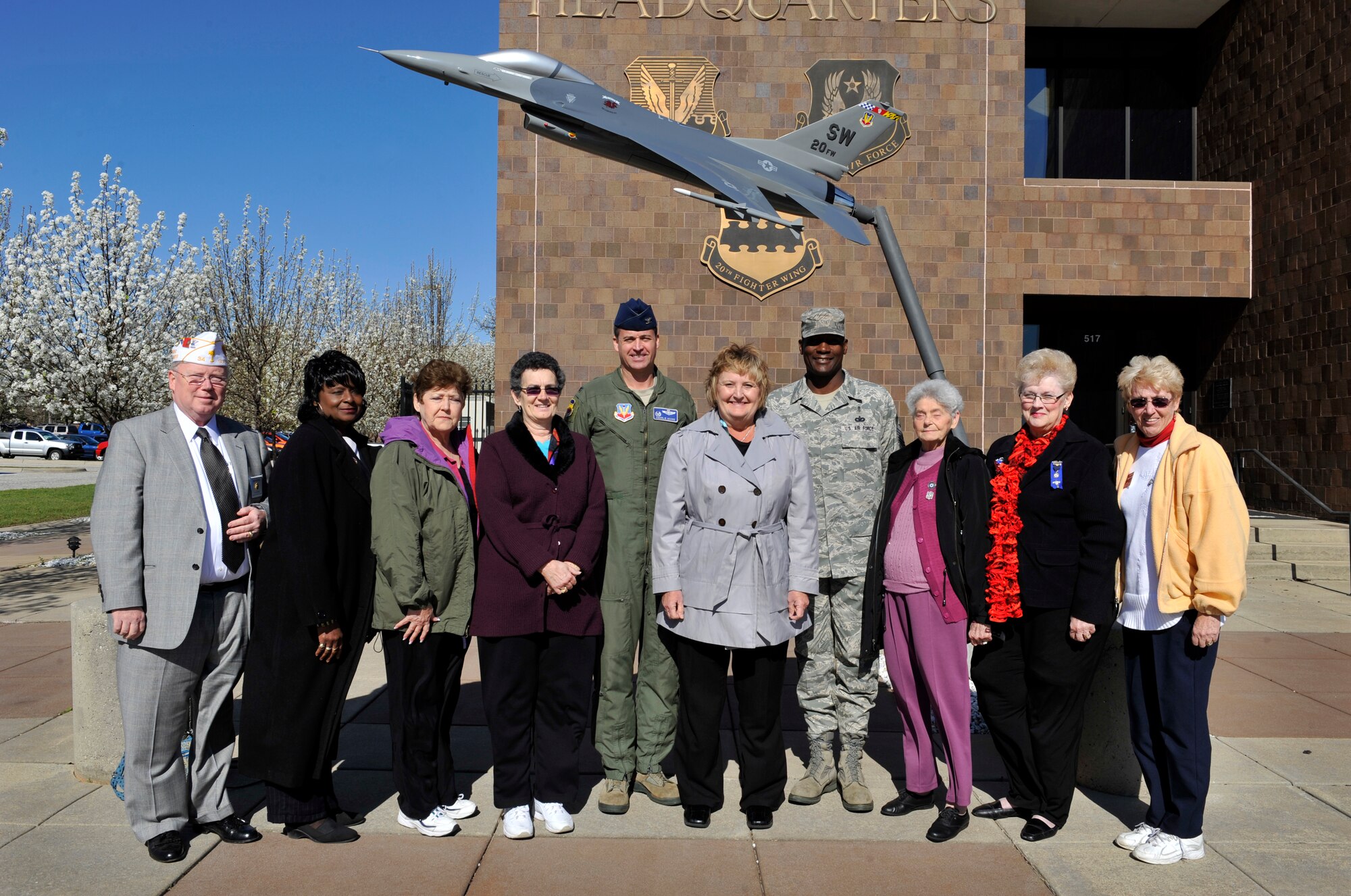 Kris Nelson (center), American Legion Auxiliary national president, and members of the South Carolina American Legion Auxiliary visit Shaw Air Force Base, S.C. Mar. 5, 2012. The members toured Shaw and met with Col. Charles Moore (center left), 20th Fighter Wing commander, and 20th FW Command Chief Master Sgt. Lefford Fate (center right). (U.S. Air Force photo by Senior Airman Amber E. N. Jacobs/Released)