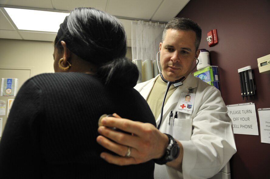 Lt. Col. Thatcher Cardon, 92nd Medical Group chief of medical staff, listens to a patients lungs in an exam room at the 92nd MDG clinic at Fairchild Air Force Base, Wash., on March 2, 2012. Cardon also volunteers as a doctor on the Spokane County Sheriff's Department Special Weapons and Tactics team in Spokane. (U.S. Air Force photo/Airman 1st Class Mary O'Dell)