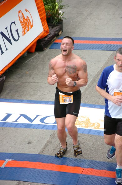 U.S. Air Force Staff Sgt. John Music, 23d Component Maintenance Squadron security manager, crosses the finish line of the ING Miami Marathon Jan. 29, 2012. Music has completed numerous marathons since 2010 when he finished the Air Force Marathon. (Courtesy photo)
