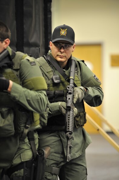 Lt. Col. Thatcher Cardon, 92nd Medical Group chief of medical staff at Fairchild Air Force Base, Wash., performs training exercises practicing dynamic entry skills with other members of the Spokane County Sheriff's Department Special Weapons and Tactics team in Spokane, Wash., on March 1 ,2012. Cardon has put in over 400 vigorous and intense hours in training for everything from search and seizure to the effects different drugs have on people leading to his voluntary position as a doctor on the team. (U.S. Air Force photo/Airman 1st Class Mary O'Dell) 