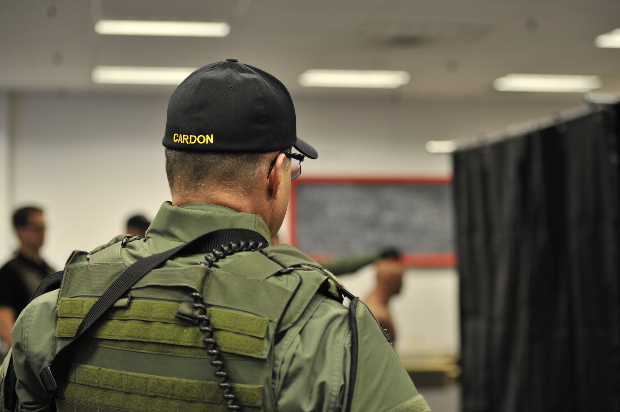Lt. Col. Thatcher Cardon, 92nd Medical Group chief of medical staff, listens on as one of his team leaders discusses the importance of timing, pace and footwork while applying tactical skills during Special Weapon and Tactics (SWAT) training exercises in Spokane, Wash., March 1, 2012. Cardon has volunteered as a doctor on the Spokane County Sheriff's Department SWAT team for almost two years with his journey beginning in Pierce County, Wash., where his interest first arose. (U.S. Air Force Photo by Airman 1st Class Mary O'Dell)