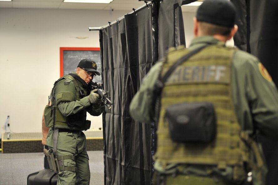Lt. Col. Thatcher Cardon, 92nd Medical Group chief of medical staff, practices dynamic entry training with another member of the Spokane County Sheriff's Department Special Weapons and Tactics team in Spokane, Wash., on March 1, 2012. The training exercises were designed to help the team apply their tactical skills while focusing on their timing, pace and footwork. (U.S. Air Force photo/Airman 1st Class Mary O'Dell)