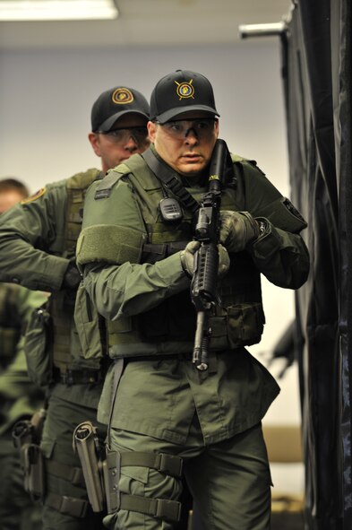 Lt. Col. Thatcher Cardon, 92nd Medical Group chief of medical staff at Fairchild Air Force Base, Wash., along with other members of the Spokane County Sheriff's Department Special Weapons and Tactics (SWAT) team, practice dynamic entry training in Spokane, Wash., on March 1, 2012. Cardon has completed over 400 hours of intense and rigorous training so that he can serve as a doctor on the SWAT team voluntarily. (U.S. Air Force photo/Airman 1st Class Mary O'Dell)