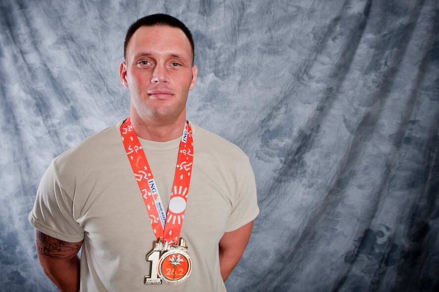 U.S. Air Force Staff Sgt. John Music, 23d Component Maintenance Squadron security manager, poses for a photo wearing his ING Miami Marathon medal Feb. 23, 2012, at Moody Air Force Base, Ga. Music participated in the marathon Jan. 29 and finished in the top 20 percent. (U.S. Air Force photo by Staff Sgt. Jamal D. Sutter/Released)