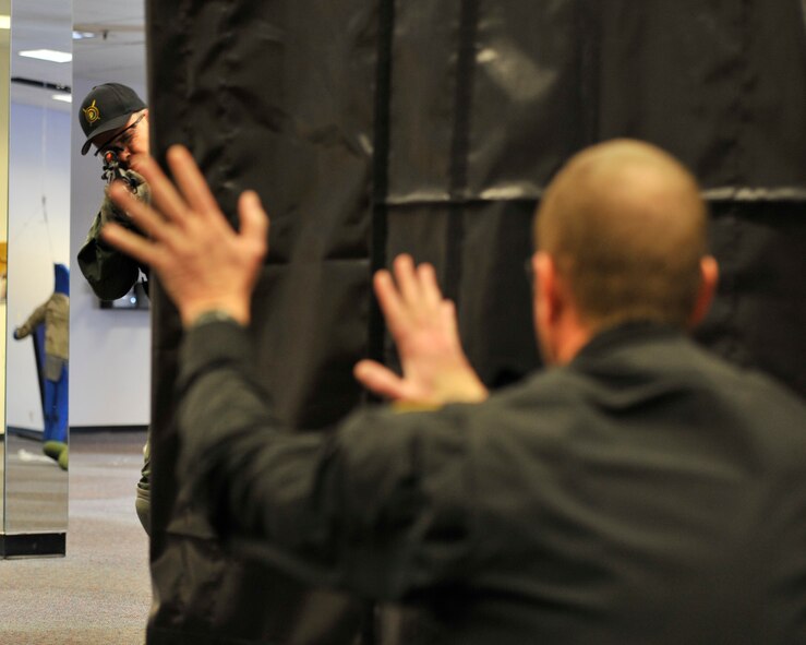 Lt. Col. Thatcher Cardon, 92nd Medical Group chief of medical staff at Fairchild Air Force Base, Wash., performs entry techniques used when clearing a corner while determining whether the suspect is a threat or not during training with the Spokane County Sheriff's Department Special Weapons and Tactical (SWAT) team in Spokane, Wash., on March 1, 2012. During the training, members of the SWAT team practiced their timing, pace and footwork while applying their skills during different exercises. (U.S. Air Force photo/Airman 1st Class Mary O'Dell)