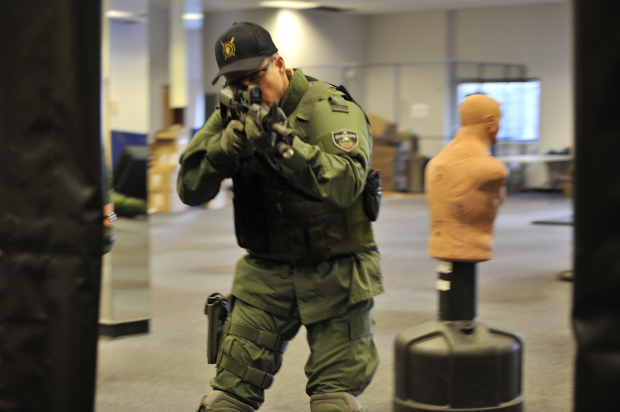 Lt. Col. Thatcher Cardon, 92nd Medical Group chief of medical staff, practices entry clearing techniques to apply when clearing a corner during training with the Spokane County Sheriff's Department Special Weapons and Tactical (SWAT) team in Spokane, Wash., March 1, 2012. Cardon has over 400 hours of training in everything from search and seizure to effects that drugs have on people and has been a volunteer doctor on the SWAT team for almost two years. (U.S. Air Force Photo by Airman 1st Class Mary O'Dell)