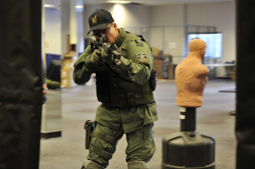 Lt. Col. Thatcher Cardon, 92nd Medical Group chief of medical staff at Fairchild Air Force Base, Wash., practices entry clearing techniques to apply when clearing a corner during training with the Spokane County Sheriff's Department Special Weapons and Tactical (SWAT) team in Spokane, Wash., on March 1, 2012. Cardon has over 400 hours of training in everything from search and seizure to effects that drugs have on people and has been a volunteer doctor on the SWAT team for almost two years. (U.S. Air Force photo/Airman 1st Class Mary O'Dell) 