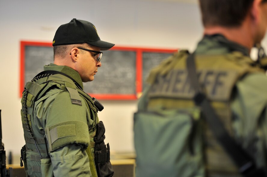 Lt. Col. Thatcher Cardon, 92nd Medical Group chief of medical staff at Fairchild Air Force Base, Wash., listens to a brief given by one of his team leaders during training with the Spokane County Sheriff's Department Special Weapons and Tactics (SWAT) team in Spokane, Wash., on March 1, 2012. Cardon has volunteered as a SWAT doctor for almost two years now, starting in Pierce County, Wash., eventually leading him to Spokane. (U.S. Air Force photo/Airman 1st Class Mary O'Dell)