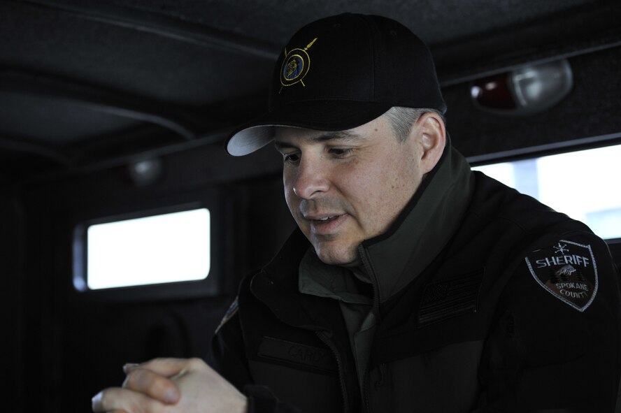 Lt. Col. Thatcher Cardon, 92nd Medical Group chief of medical staff at Fairchild Air Force Base, Wash., sits in a "Bear Cat" armored vehicle on his way to train with the Spokane County Sheriff's Department Special Weapons and Tactics (SWAT) team in Spokane, Wash., on March 1, 2012. Cardon utilizes his skills as a doctor for the SWAT team in situations that they are needed. (U.S. Air Force photo/Airman 1st Class Mary O'Dell) 