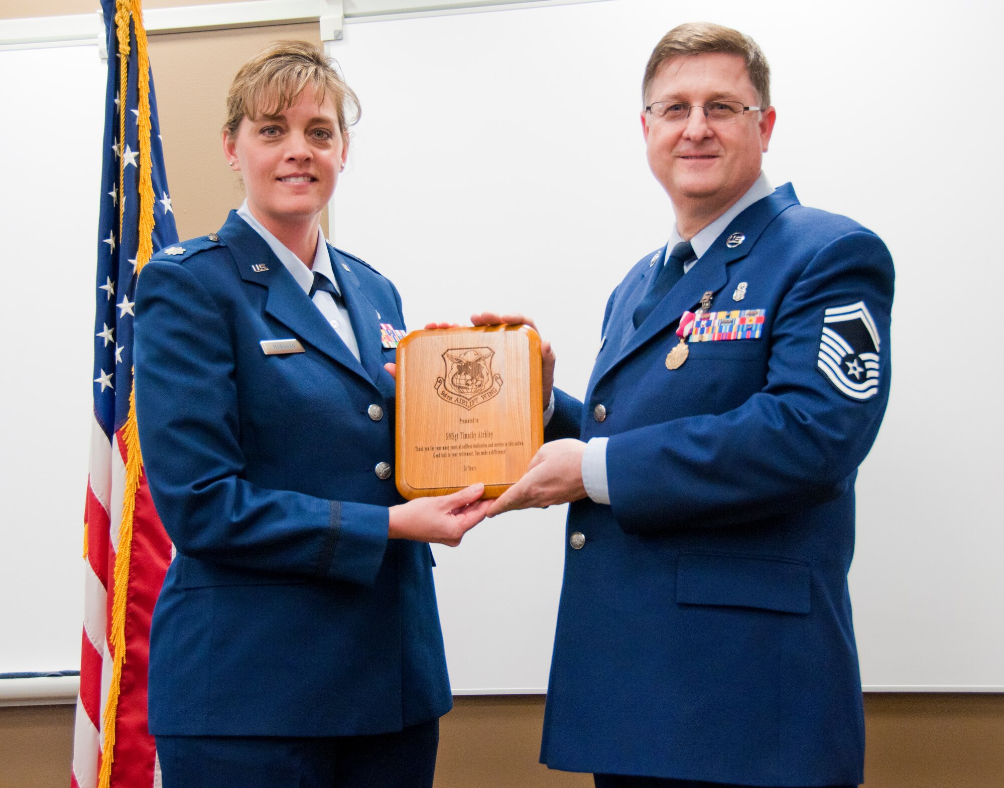 Senior Master Sgt. Timothy O. Atchley receives a plaque from Lt. Col. Tracy L. Monahan, commemorating his 24 years of military service during his retirement ceremony at the 934th Aeromedical Staging Squadron on March 4, 2012.  Sergeant Atchley will remain with ASTS as a civilian employee at the Minneapolis-St. Paul Air Reserve Station, Minn.  (Air Force Photo/Tech. Sgt. Jim Loehr)