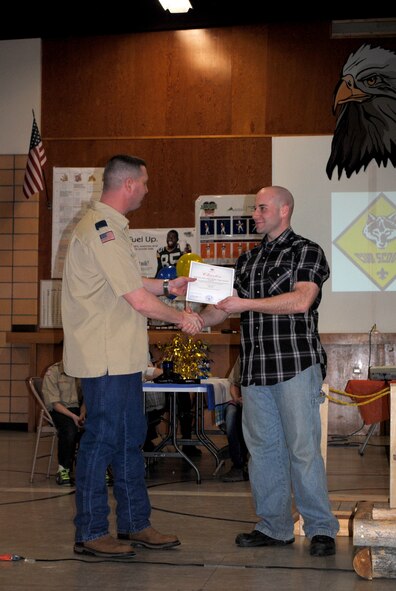 Maj. Wade Wilmoth, assistant cubmaster for the Cub Scouts Pack 43, presents Staff Sgt. Timothy Lombardi, 341st Security Support Squadron security forces member, with a certificate of appreciation.  Lombardi was representing Malmstrom's 5/6 Alliance, which is a sponsor of Pack 43.  (U.S. Air Force photo/Airman 1st Class Cortney Paxton)