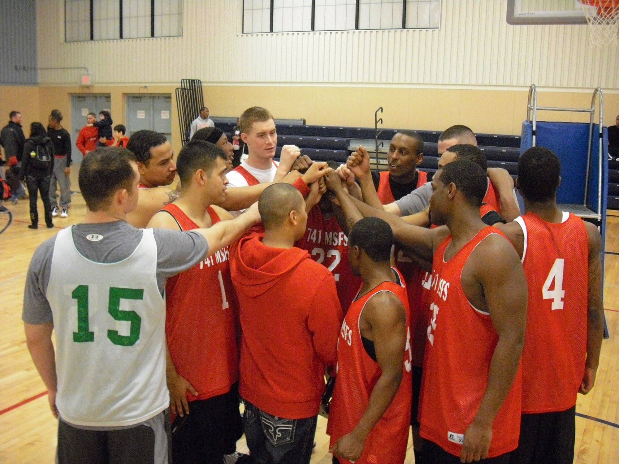 Members of the 741st Missile Security Forces Squadron basketball team huddle up before returning to their final game Feb. 24 against the 819th RED HORSE Squadron.  The team ended up being undefeated champions and received a trophy.  (U.S. Air Force courtesy photo)
