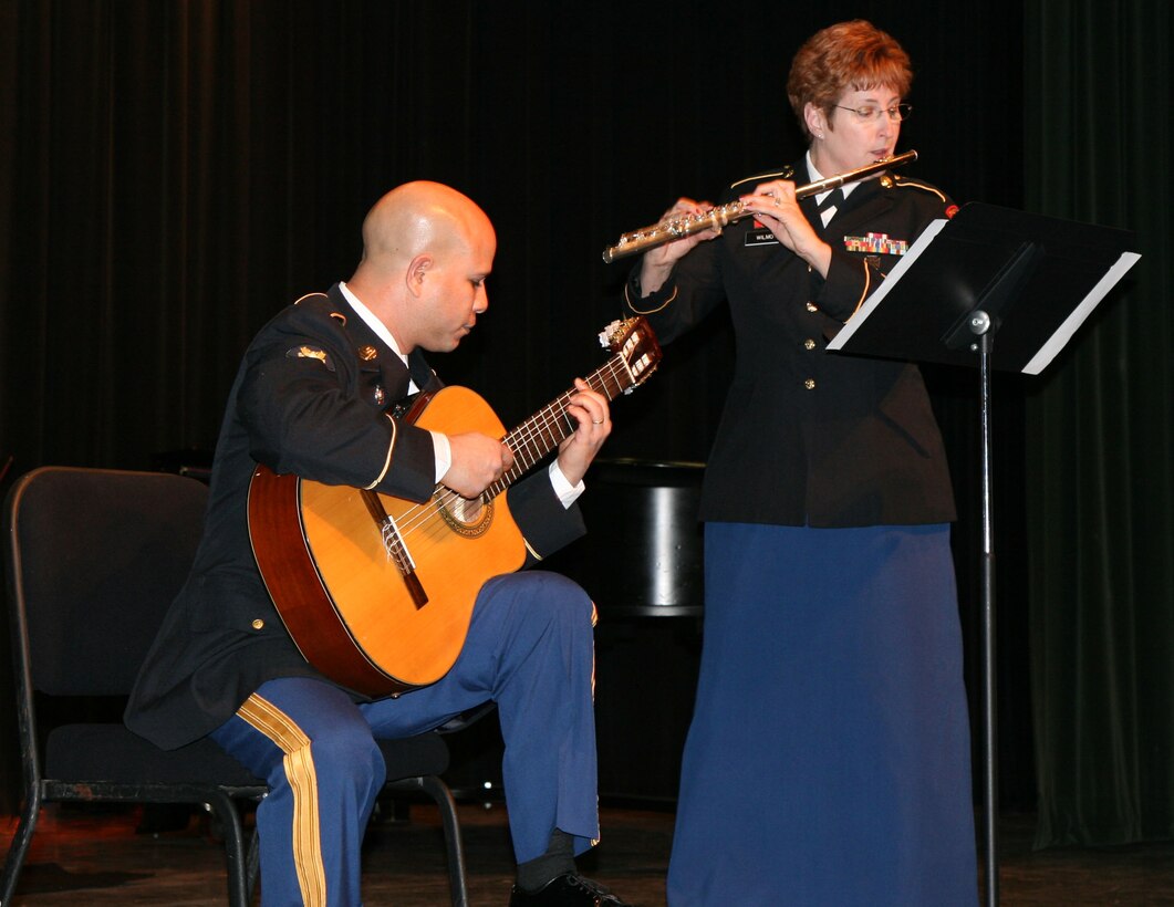 U.S. Army Staff Sgt. Darla Wilmot (flute) and Spc. Nestor Semidei (guitar) perform at the Williamsburg Library Theatre Feb. 23, as part of the U.S. Army Training and Doctrine Command Band's Winter Chamber Music Concert Series. The duo was one of many outstanding chamber music ensembles performing that night, including a saxophone quartet, brass quintet, trombone sextet and a New Orleans Jazz group. This performance was one of the many community outreach concerts given by the TRADOC Band's active duty soldiers in recent months. (U.S. Army Photo by Staff Sgt. James Cipriano/Released)