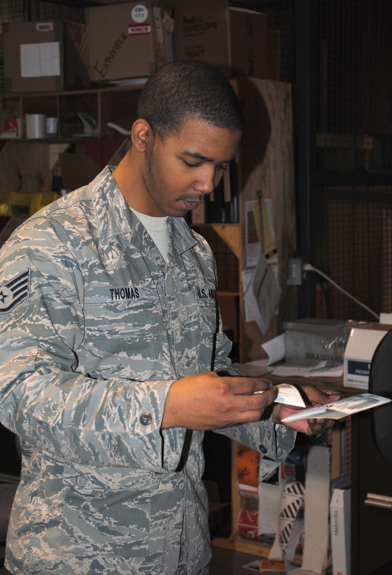 Staff Sgt. Sir Thomas, 341st LRS NCO in charge of packing and crating, verifies a package label before placing it on its box. Checking and rechecking is a common procedure. (U.S. Air Force file/Airman 1st Class Cortney Paxton)