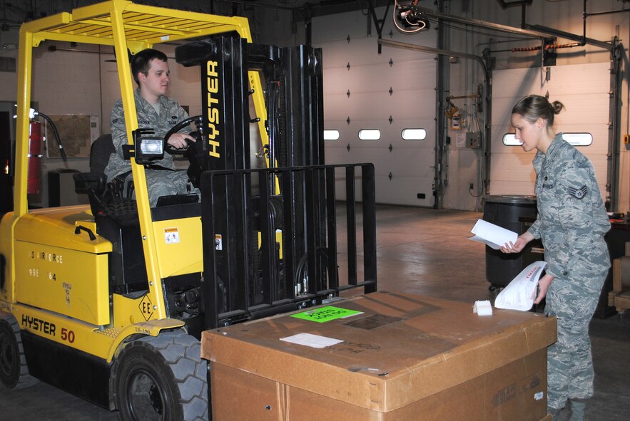 Airman 1st Class James McCracken, 341st Logistics Readiness Squadron traffic management apprentice, operates a forklift under direction of Staff Sgt. Saniel Clarey, 341st LRS NCO in charge of packing and crating. (U.S. Air Force file/Airman 1st Class Cortney Paxton) 
