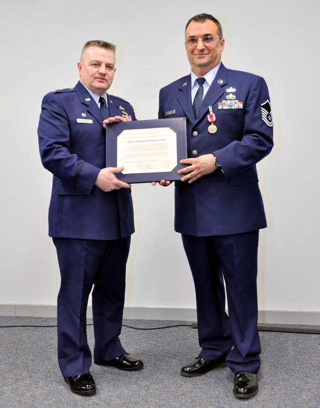 Master Sgt. Anthony J. Lamia receives a certificate of appreciation from Lt. Col Bryan G. Anders during a ceremony March 3, 2012, for his retirement from the 934th Civil Engineering Squadron at the Minneapolis-St. Paul Air Reserve Station, Minn.  (Air Force Photo/Tech Sgt. Jim Loehr)