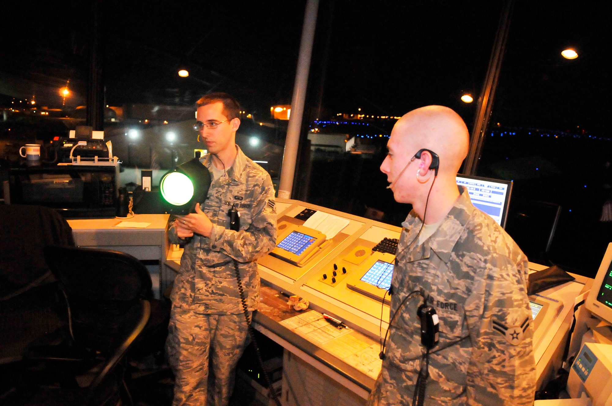 Senior Airman William Farmer (left), air traffic controller, demonstrates a light gun, used to signal aircraft in the event of a loss of  communication.  (U. S. Air Force photo by Sue Sapp)