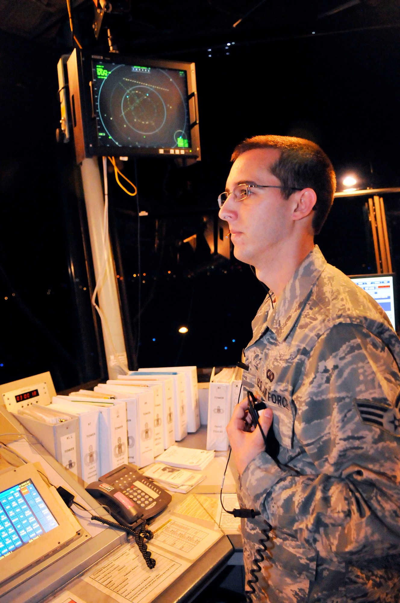 Senior Airman William Farmer, air traffic controller, keeps an eye on the runway from the control tower. (U. S. Air Force photo by Sue Sapp)