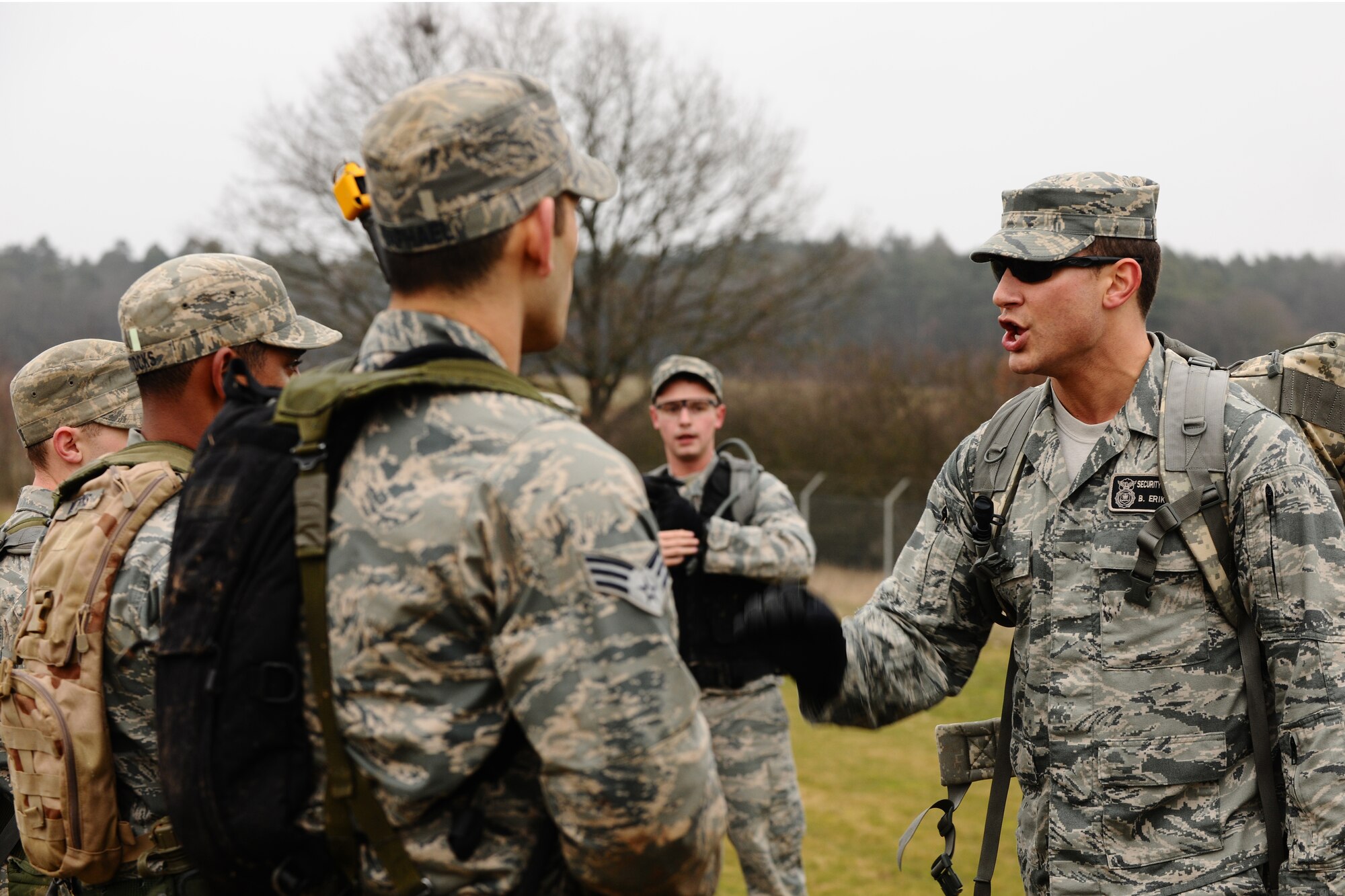 SPANGDAHLEM AIR BASE, Germany – Technical Sgt. Blake Eriksen, 52nd Security Forces Squadron Combat Arms Training and Maintenance instructor, gives commands to Airmen participating in the patrolling training portion of the Ranger training course in a field next to Perimeter Road here March 3. The three-day course prepares Airmen for what they will be tested on during the U.S. Army Ranger pre-assessment training course. The course tests service members’ physical and mental abilities in a high-stress environment while still helping the Ranger learn new skills and improve existing knowledge. Out of the five Airmen enrolled in the training, Senior Airman Sean Reval, 52nd Security Forces Squadron, and Senior Airman Coty Raphael, 52nd Medical Operations Squadron, were the only participants to qualify to continue on to Ranger pre-assessment training at Sembach Air Base, Germany. (U.S. Air Force photo by Airman 1st Class Dillon Davis/Released)