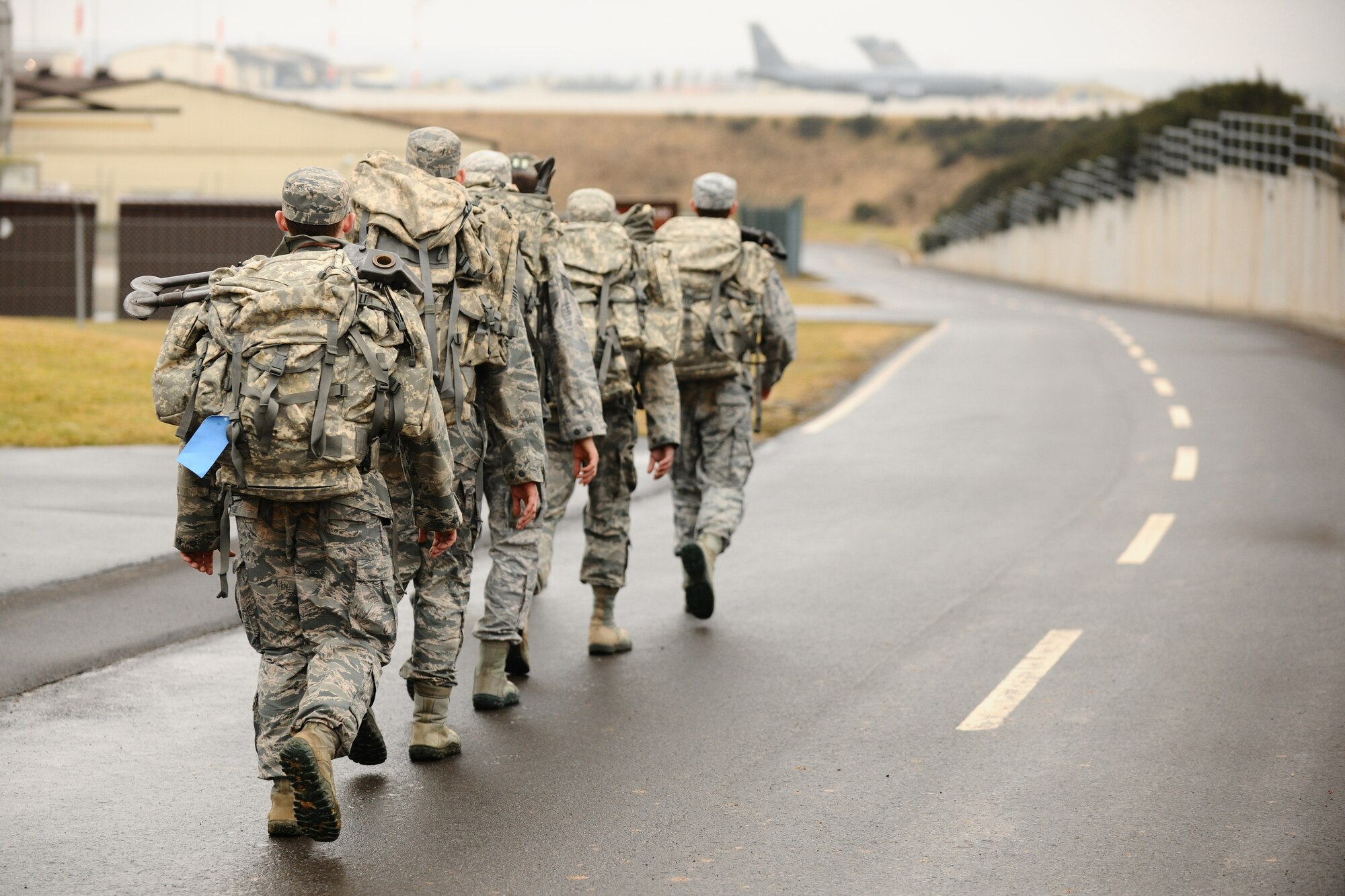 SPANGDAHLEM AIR BASE, Germany – Airmen assigned to Spangdahlem AB ruck march down a road outside Bldg. 630 here before they begin the bag drag portion of the Ranger training course March 2. Any male Airman can volunteer for the annual training if they are serious about becoming a U.S. Army Ranger and their chain of command allows him to participate. The required three-day course prepares Airmen for what they will be tested on during the Ranger training school at U.S. Army Fort Benning, Ga. Out of the five Airmen enrolled in the training, Senior Airman Sean Reval, 52nd Security Forces Squadron, and Senior Airman Coty Raphael, 52nd Medical Operations Squadron, were the only participants to qualify to continue on to Ranger pre-assessment training at Sembach Air Base, Germany. (U.S. Air Force photo by Airman 1st Class Dillon Davis/Released)
