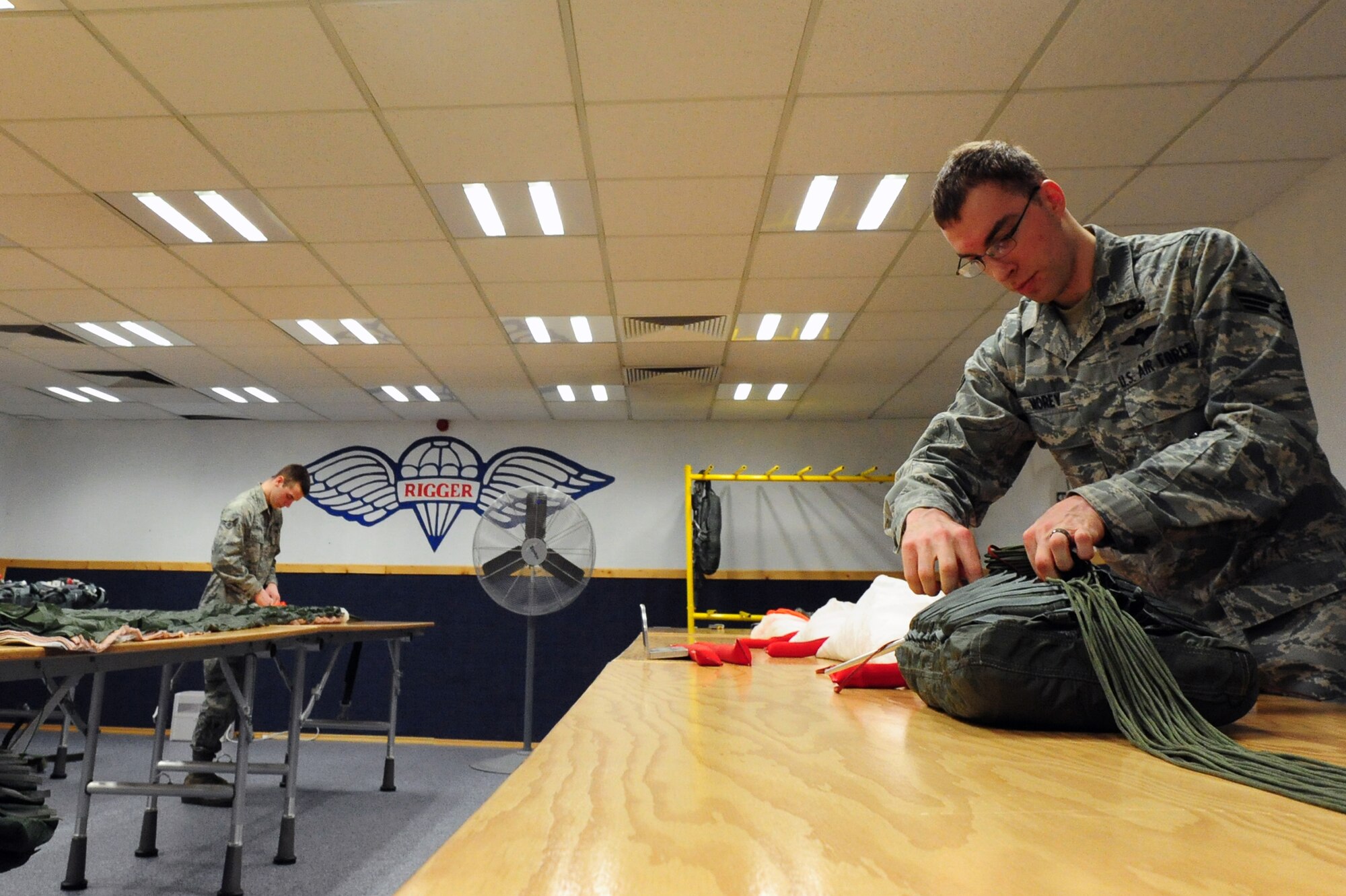 Senior Airman Gabriel Morey, 86th Operation Support Squadron aircrew flight technician, installs locking loops to rip chords that initiate the activation of the parachute Ramstein Air Base, Germany, March 5, 2012. The life support organization ensures safety and knowledge of life support and survival equipment. (U.S. Air Force photo by Senior Airman Aaron-Forrest Wainwright)