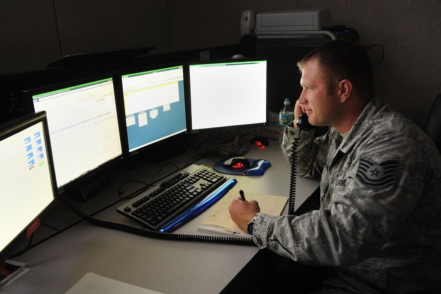 MACDILL AFB, Fla. -- Tech. Sgt. Chris Sterling, 927th Maintenance Operations Flight, takes information from a caller while monitoring maintenance logs on several screens March 3, 2011, at Macdill Air Force Base, Florida.  Sgt. Sterling is an aircraft production controller at the Maintenance Operations Conrol Center, which serves as a clearinghouse of information for all issues related to maintenance on the flightline.  (U.S. Air Force photo/Staff Sgt. Jennie Chamberlin)