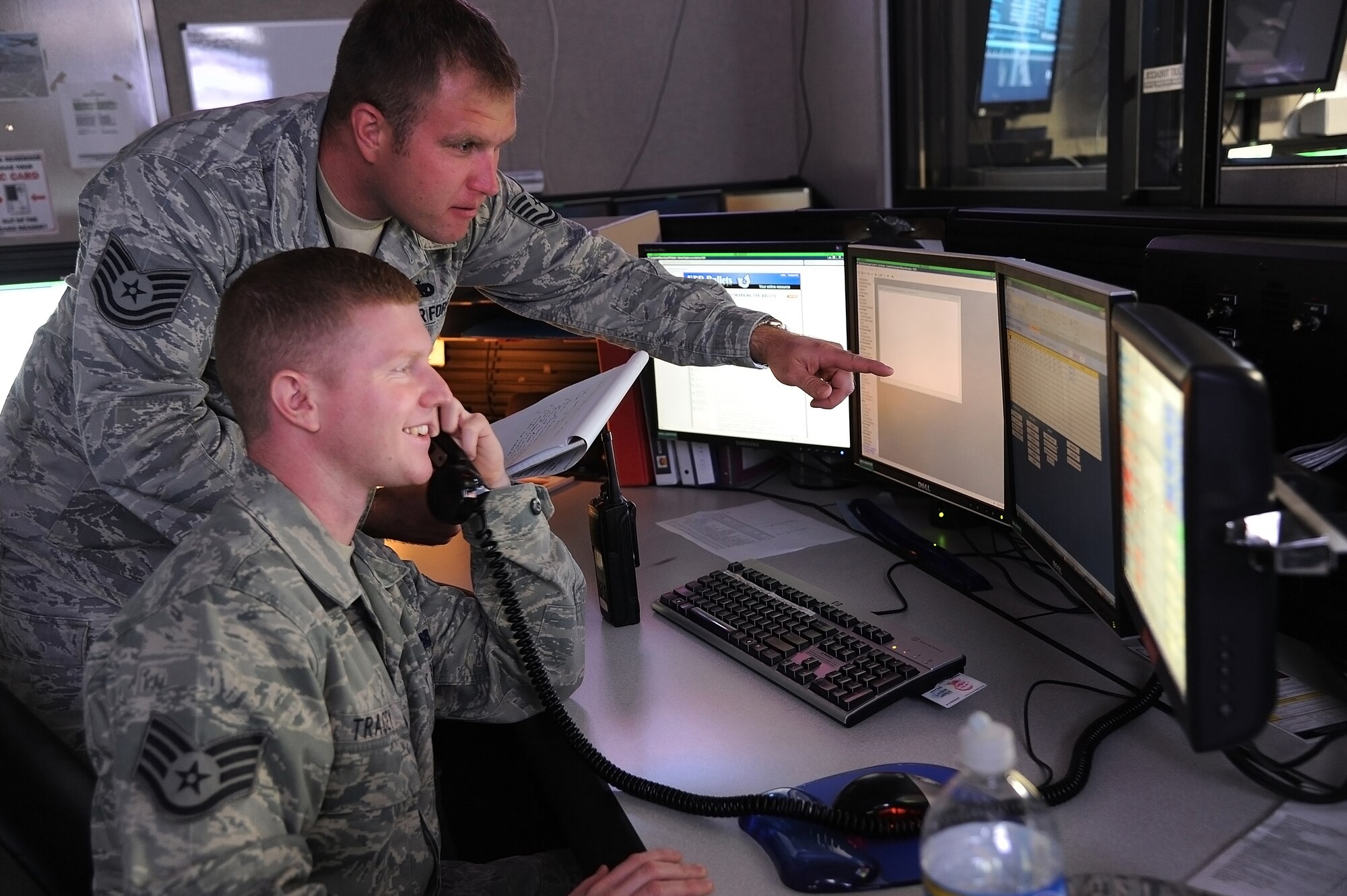 MACDILL AFB, Fla. --Tech. Sgt. Chris Sterling and Staff Sgt. Sean Tracey, 927th Maintenance Operations Flight, take information from a caller while monitoring maintenance logs on several screens March 3, 2011, at Macdill Air Force Base, Florida.  Sgt. Sterling and Sgt. Tracey are aircraft production controllers at the Maintenance Operations Conrol Center, which serves as a clearinghouse of information for all issues related to maintenance on the flightline.  (U.S. Air Force photo/Staff Sgt. Jennie Chamberlin)