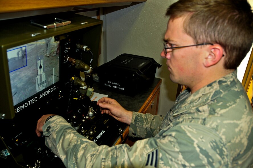 Senior Airman Tre McGowan from the 919th Civil Engineer Squadron explosive ordnance disposal flight operates the F6A robot during a Chemical, Biological, Radiological, Nuclear Improvised Explosive Device operation at Hurlburt Field.  The exercise provided training to deploy a F6A robot platform.  The robot is used to safely conduct EOD operations without the operator having to expose himself to an explosive device.  (U.S. Air Force photo/Tech. Sgt. Jasmin Taylor)