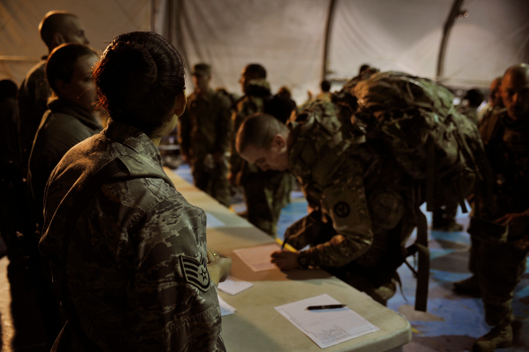 BAGRAM AIRFIELD, Afghanistan— Military members register to participate in the Senior Airman Jason Cunningham Remembrance Ruck March at Bagram Airfield, Afghanistan, March 4, 2012. Cunningham, a pararescueman who died in combat on March 4, 2002, saved 10 men’s lives by giving medical aid while under fire. The Air Force’s Camp Cunningham at Bagram is named in his honor. (U.S. Air Force photo/Airman 1st Class Ericka Engblom)