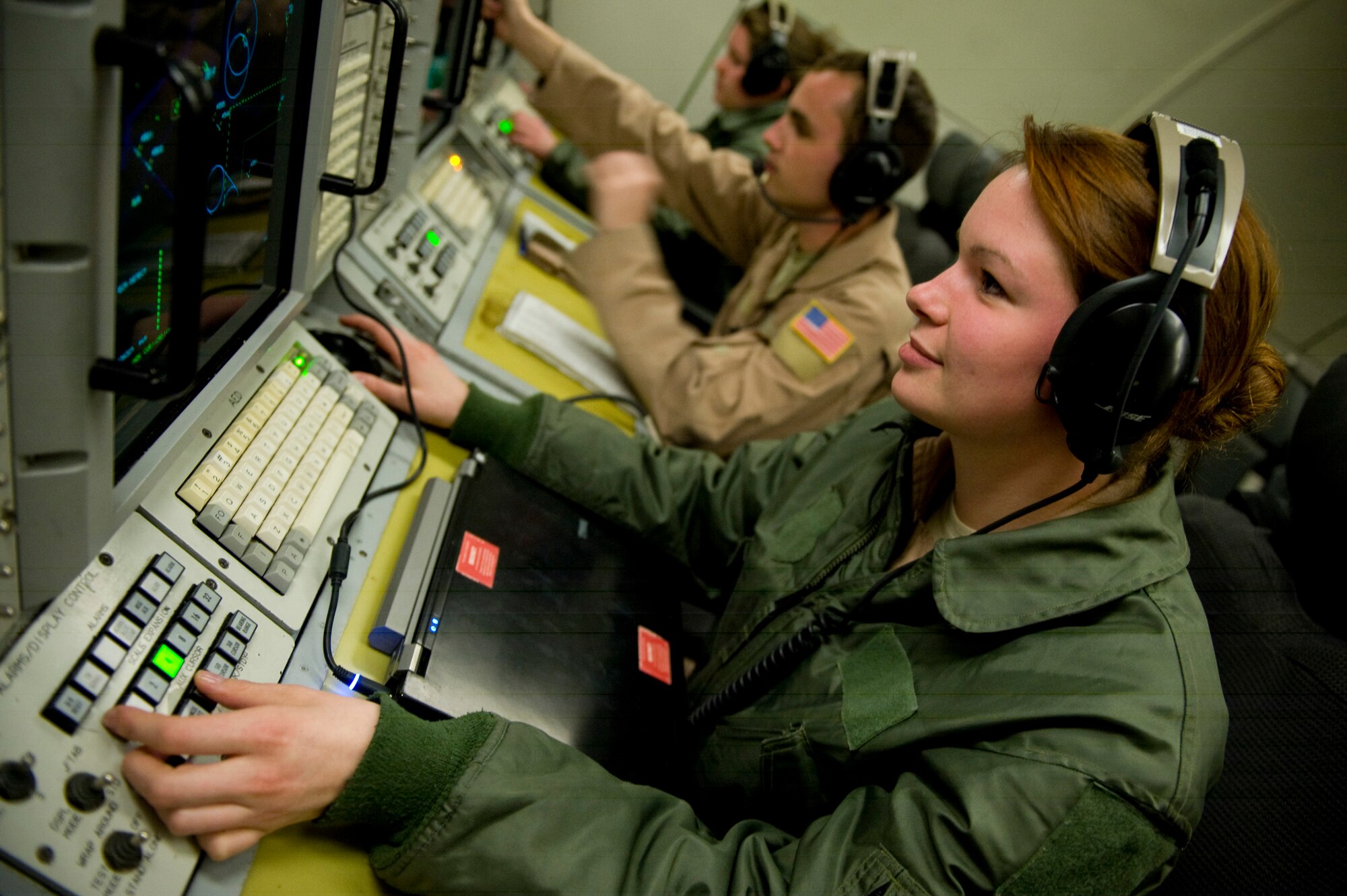 U.S. Air Force Airman 1st Class Annie Coney, Senior Airman Jeremiah Snyder and Airman 1st Class Madelyn Kirin, E-3 Sentry (AWACS)  airborne sensor operators with the 964th Expeditionary Airborne Air Control Squadron, monitor aircraft over Afghanistan, Feb. 29, 2012. The mission of the 964th EAACS is to provide an accurate, real-time picture of the battlespace to the Joint Air Operations Center. The E-3 Sentry crew also provides situational awareness of friendly, neutral and hostile activity, command and control of an area of responsibility, battle management of theater forces, all-altitude and all-weather surveillance of the battle space, and early warning of enemy actions during joint, allied, and coalition operations. (U.S. Air Force photo by Staff Sgt. Greg C. Biondo)(Released)
