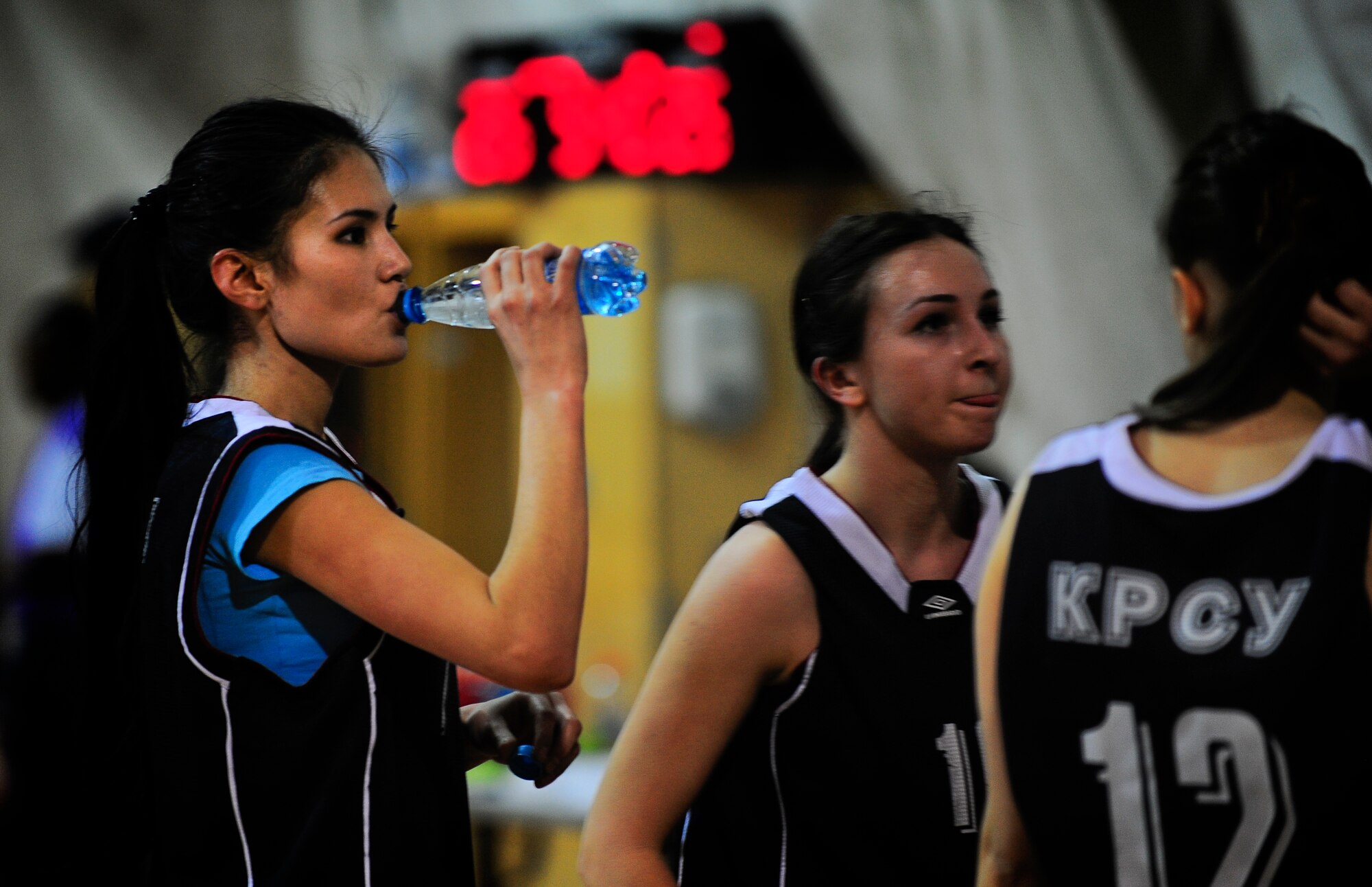 Muhtaram Akmatova takes a drink of water during a Kyrgyz and American friendship basketball game to celebrate International Women's Day March 3, 2012, at the Transit Center at Manas, Kyrgyzstan. Akmatova is a player the Kyrgyz-Russian Slavic University women's basketball team.(U.S. Air Force Photo/Staff Sgt. Angela Ruiz)