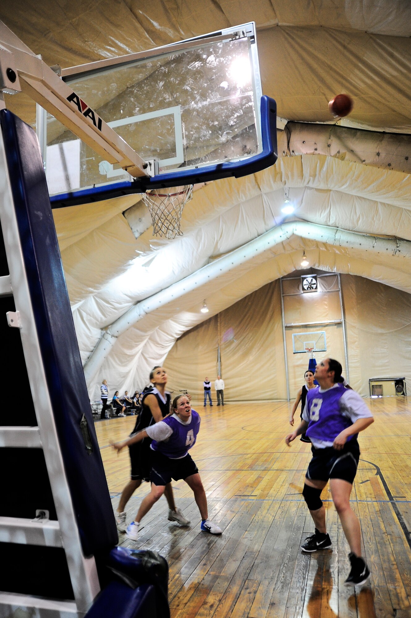 Transit Center at Manas women's basketball team members block players of the Kyrgyz-Russian Slavic University women's basketball team March 3, 2012, during a Kyrgyz and American friendship basketball game at the Transit Center at Manas, Kyrgyzstan. The game was held to celebrate International Women's Day on March 8. (U.S. Air Force Photo/Staff Sgt. Angela Ruiz)