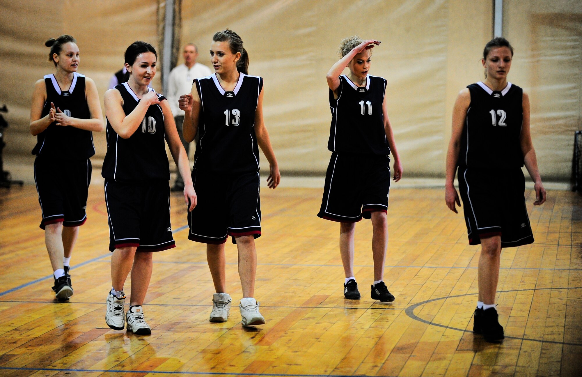Players from the Kyrgyz-Russian Slavic University women's basketball team walk onto the court March 3, 2012, at the Transit Center at Manas, Kyrgyzstan. The team competed against the Transit Center in Celebration of International Women's Day March 8. This was the third time the Transit Center and the Kyrgyz team have played against eachother. (U.S. Air Force Photo/Staff Sgt. Angela Ruiz)